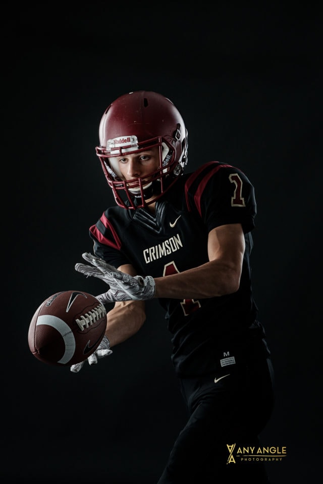 Senior guy pictures of football player in studio with dark background