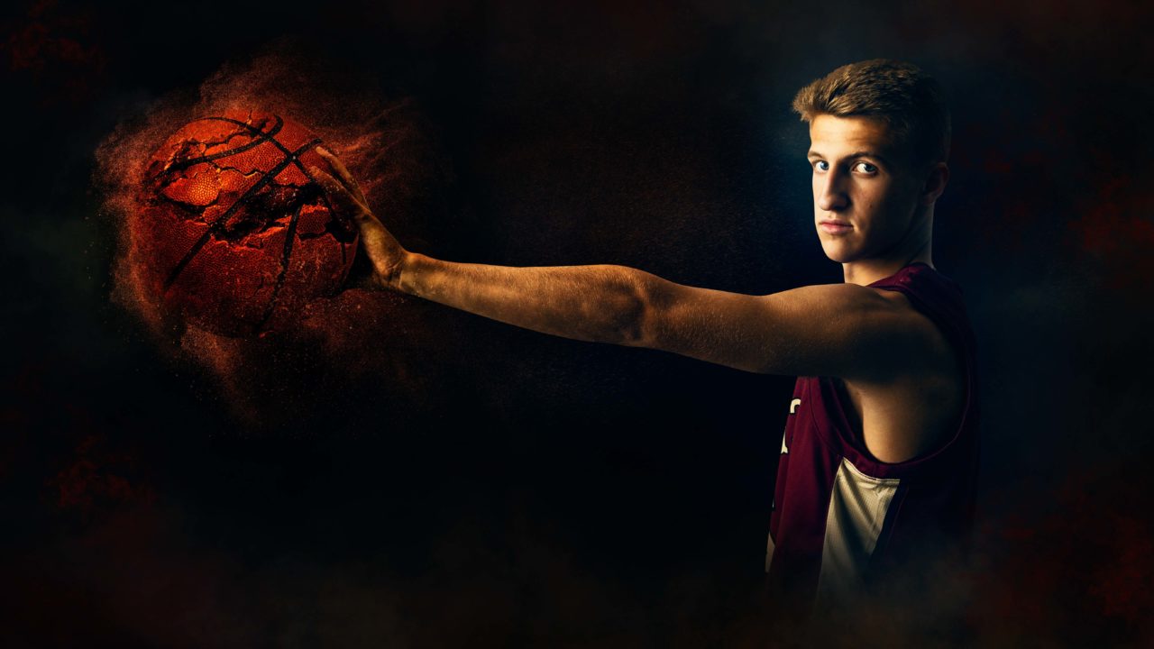 Minneapolis senior pictures of Maple Grove Senior High basketball player athlete extending his arm and crushing a basketball. Captured by Minnesota Senior Sport Photographer Any Angle Photography.