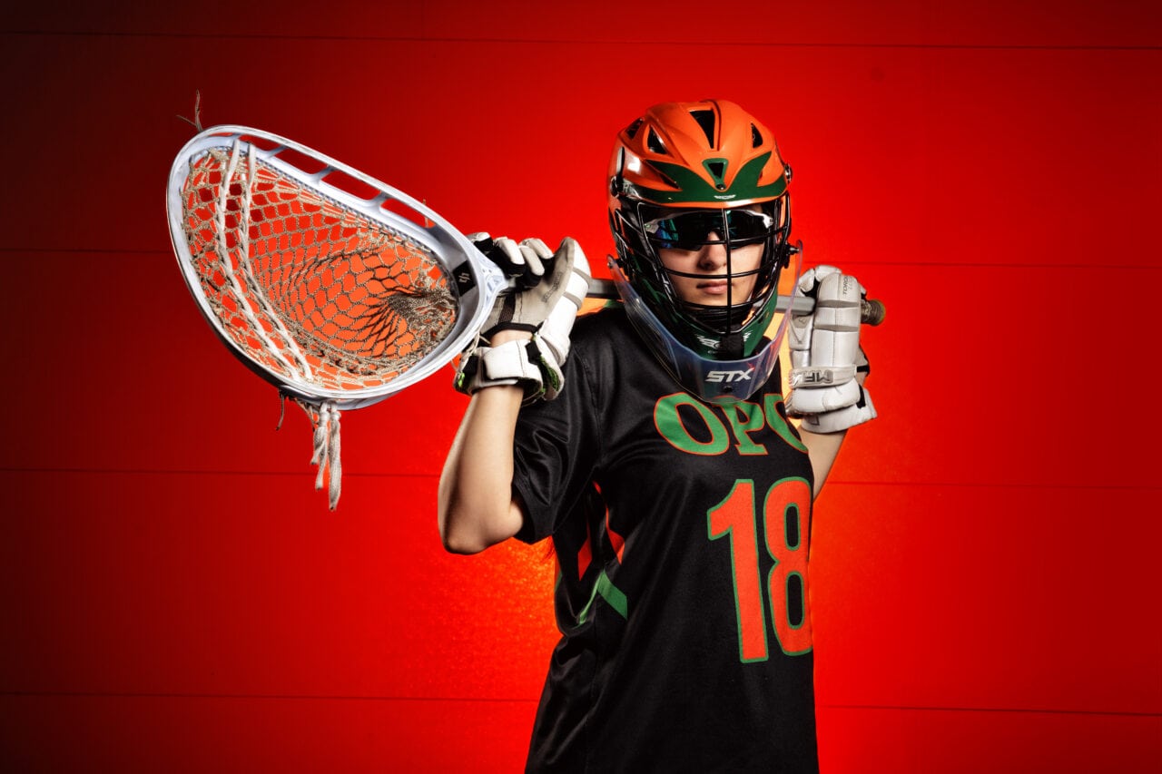Senior pictures with lacrosse player at Osseo High School in Minneapolis. Captured by Any Angle Photography.