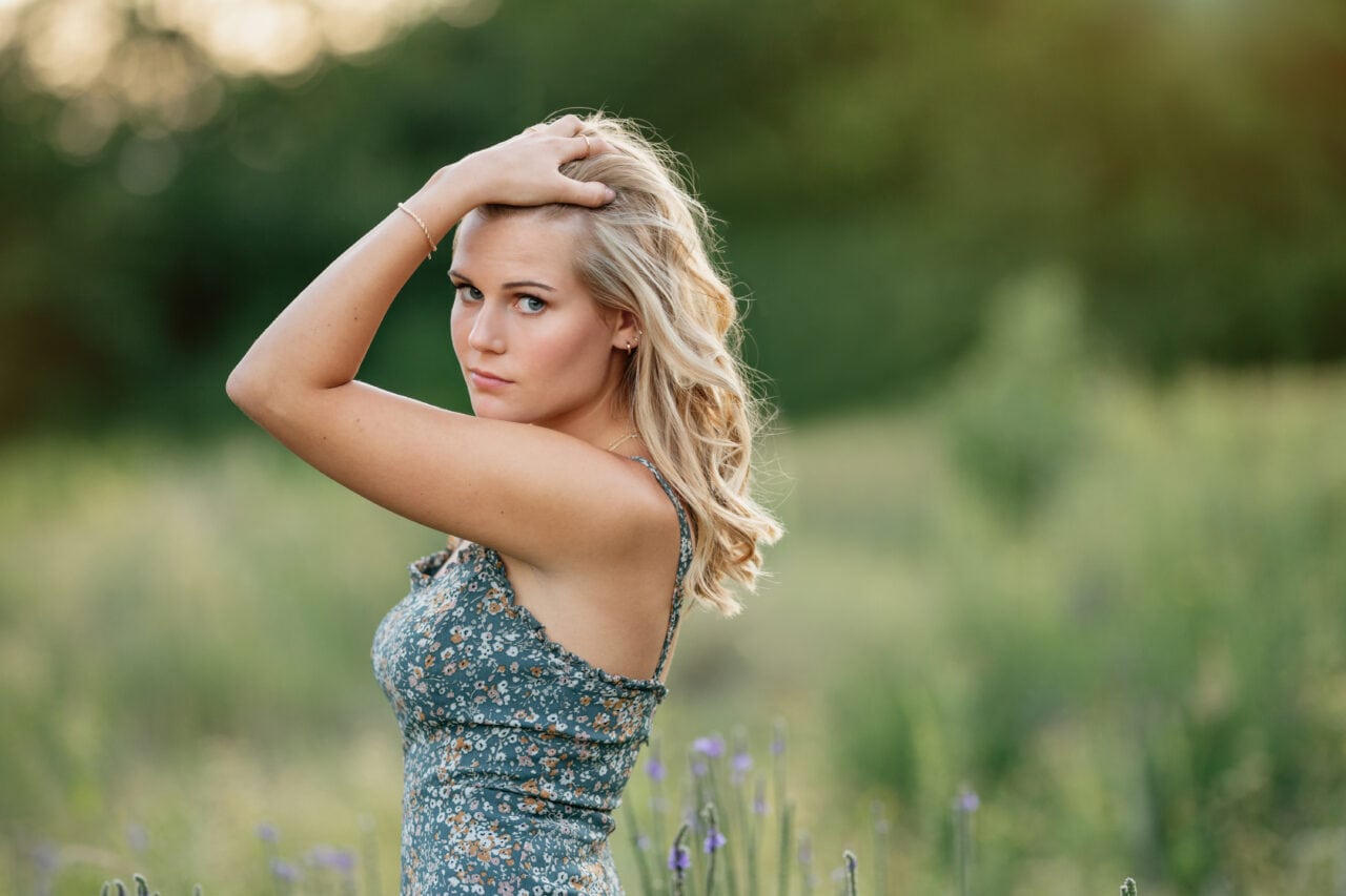 Senior pictures with girl in field in Minneapolis. Captured by Minneapolis senior photographer Any Angle Photography.